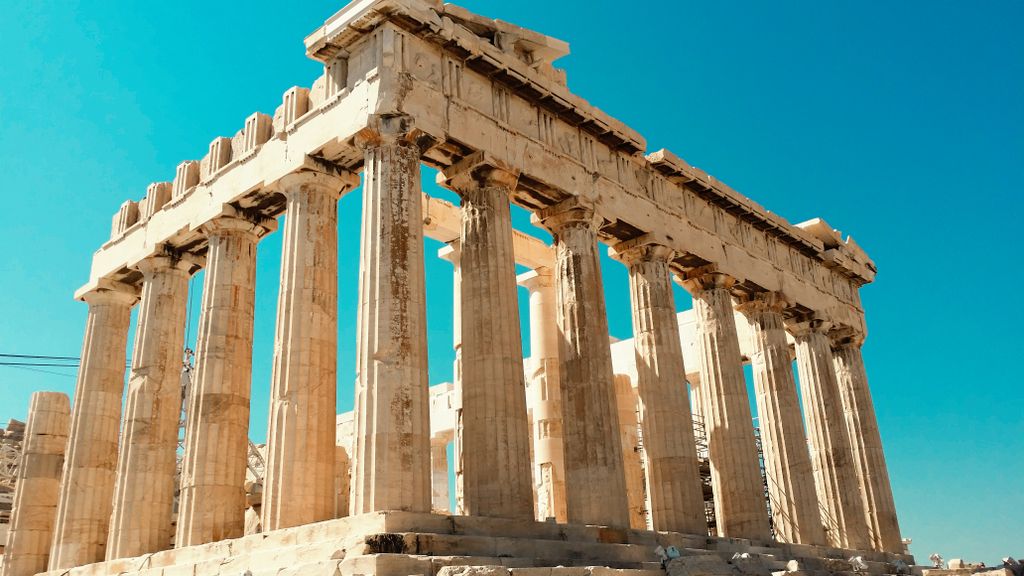 Impressive view of the ancient Parthenon in Athens against a clear blue sky.